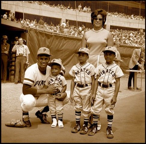 Roberto Clemente with his three sons at Three Rivers Stadium early in the 1972 baseball season. From left: Roberto; Enrique; Luis; and Roberto Jr. Wife Vera is standing.